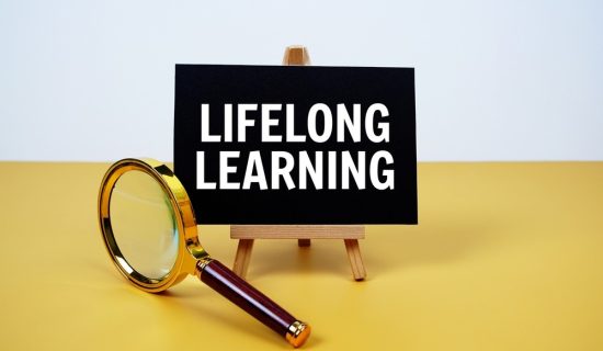 Lifelong,Learning,Text,On,Paper,Card,With,Magnifying,Glass,On